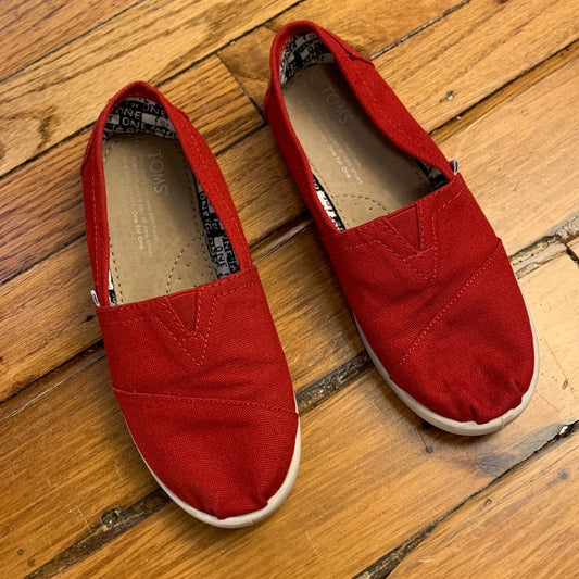 Toms red slip on canvas shoes, size 2