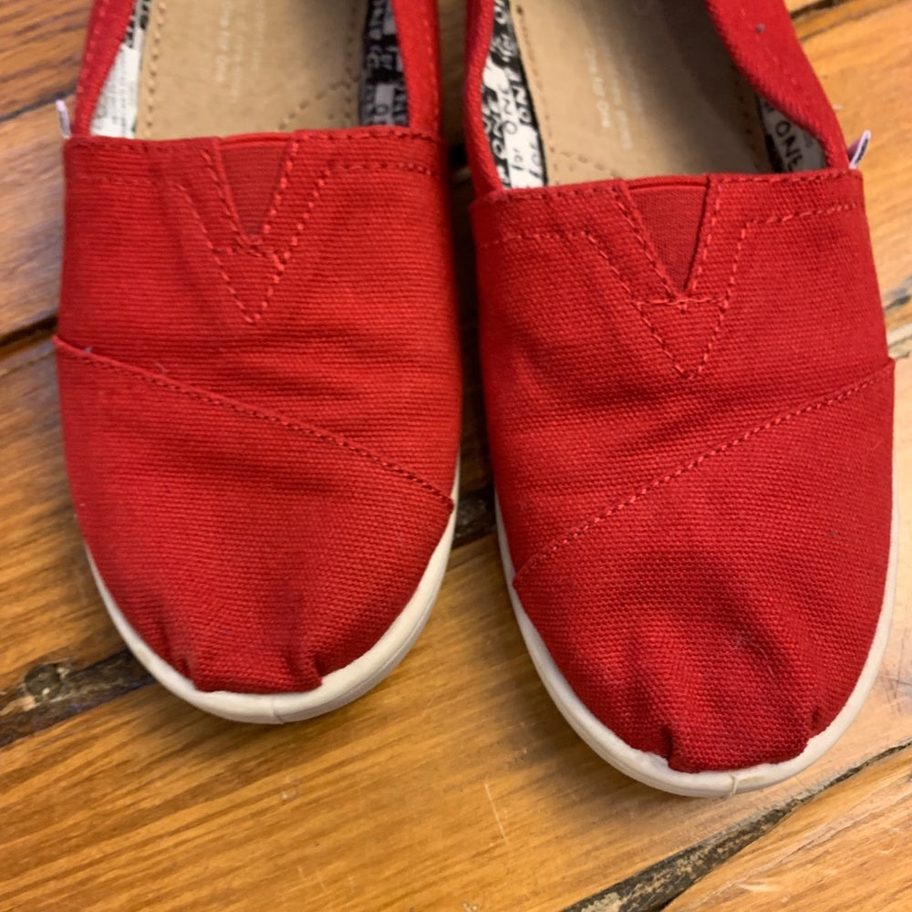 Toms red slip on canvas shoes, size 2